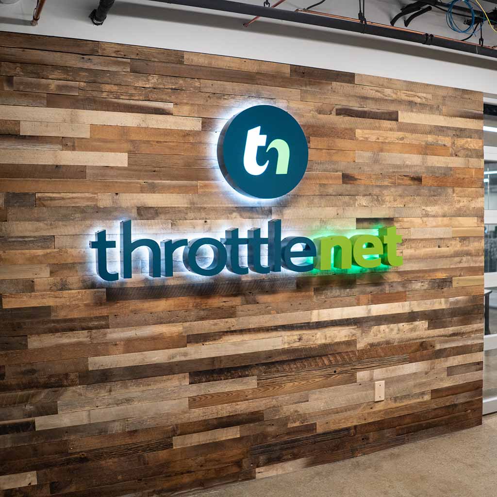 Throttlenet logo on wood panel wall